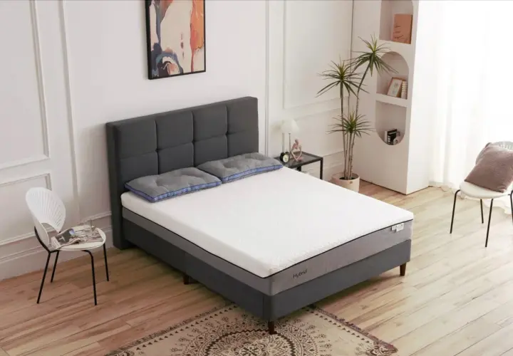 Un lit moderne avec un matelas hybride, idéal pour savoir quel sommier pour matelas hybride choisir.