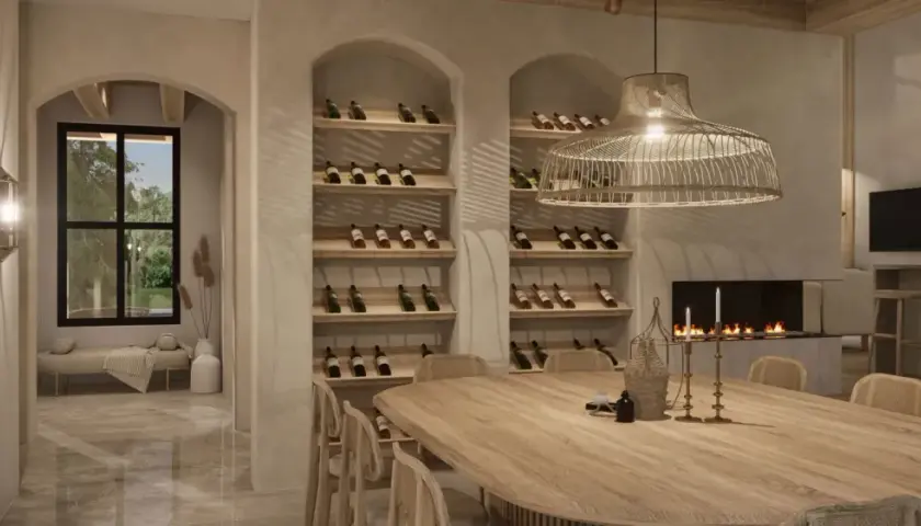 Salle à manger chaleureuse avec une grande table en bois, des étagères à vin remplies, une cheminée et une ambiance deco boho chic.