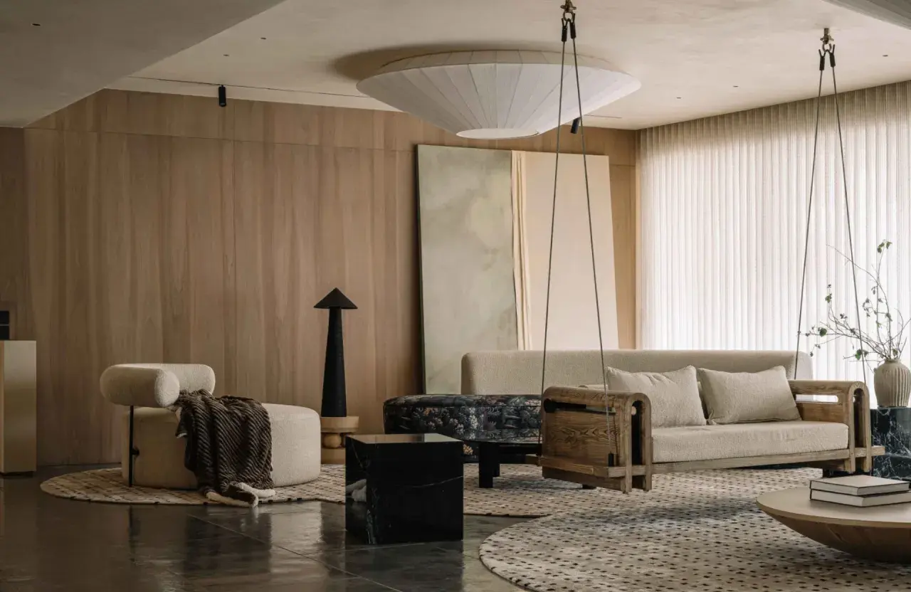 Salon moderne avec fauteuil cosy, canapé suspendu en bois, et une touche d'inspiration déco appartement dans des tons naturels.