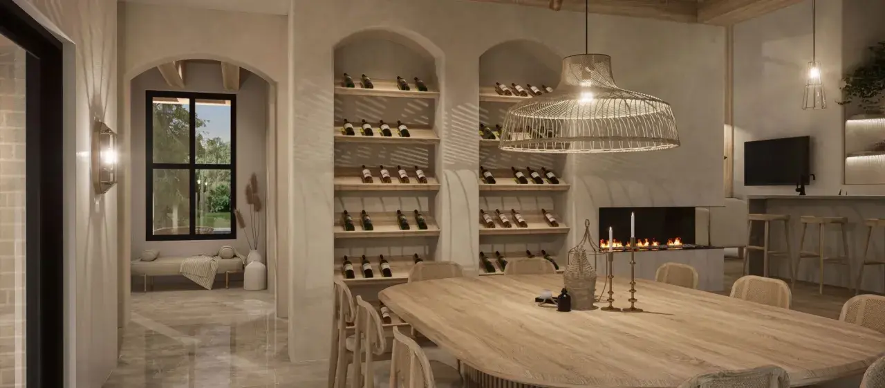 Salle à manger chaleureuse avec une grande table en bois, des étagères à vin remplies, une cheminée et une ambiance deco boho chic.