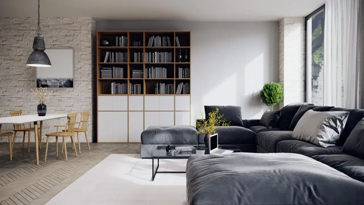 Un grand canap&eacute; gris fonc&eacute; repose sur un tapis blanc cass&eacute;, cr&eacute;ant un contraste doux. Une table basse noire et des poufs gris compl&egrave;tent l'ensemble.